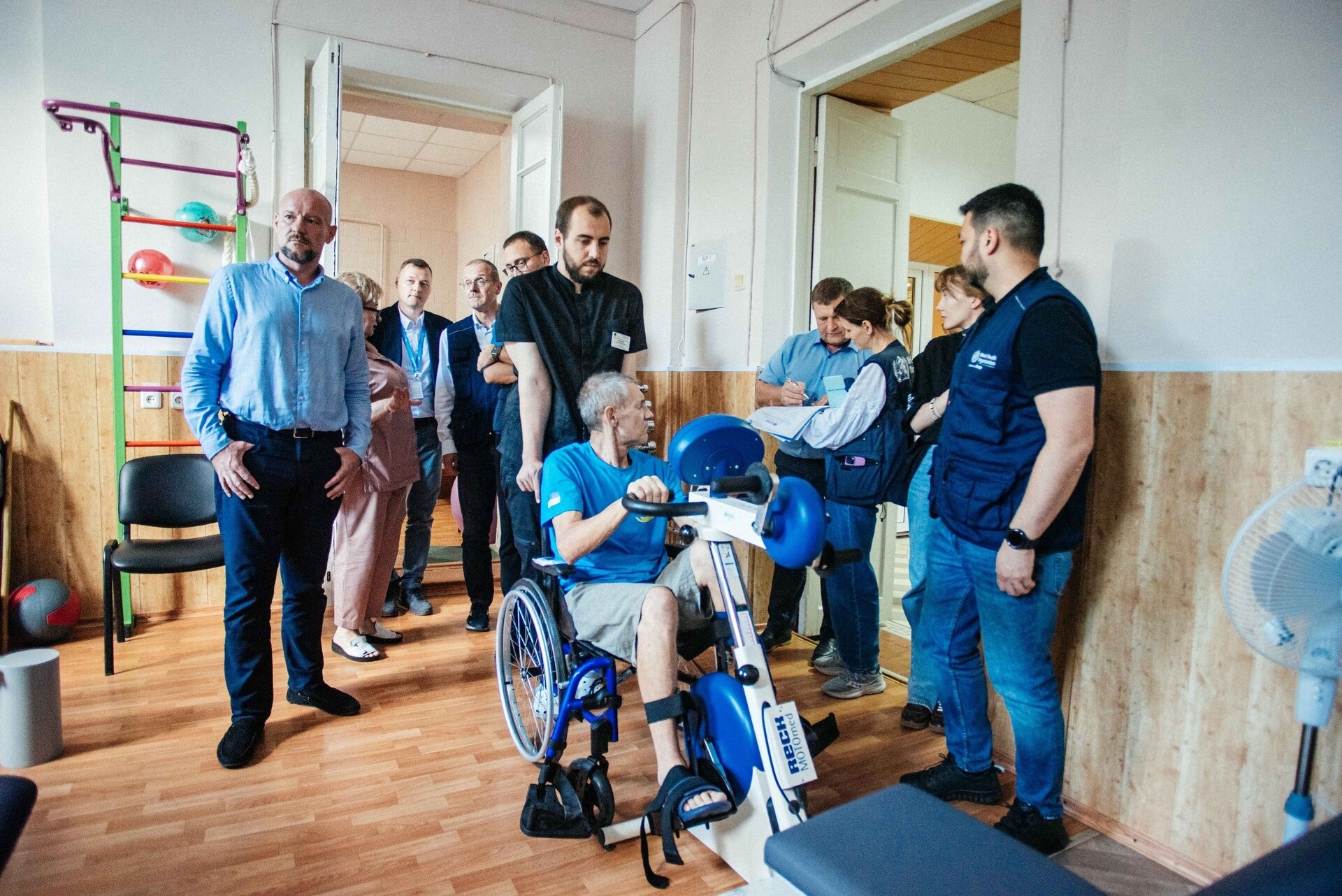 WHE 2025 Appeal Impact in 2024 Ukraine A group of people standing around a person in a wheelchair.