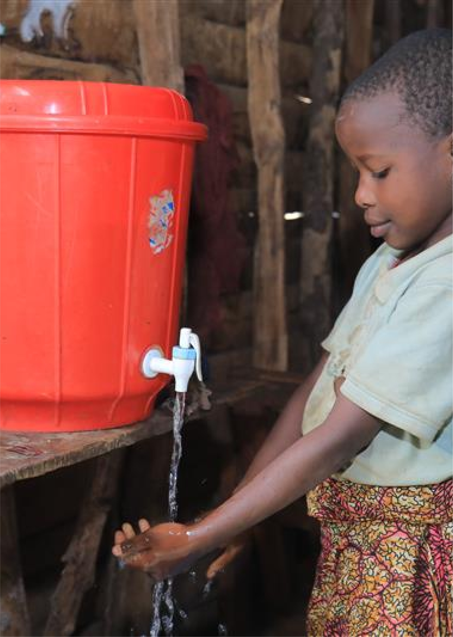 WHE 2025 Appeals listing DRC A young girl is washing her hands under a tap on a large red water container.