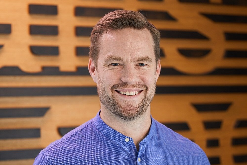 Profile photo of a man smiling into the camera.