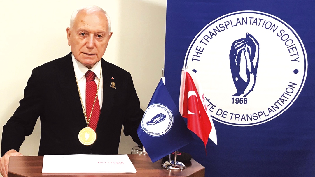 Prof Mehmet Haberal at a podium during a ceremony.