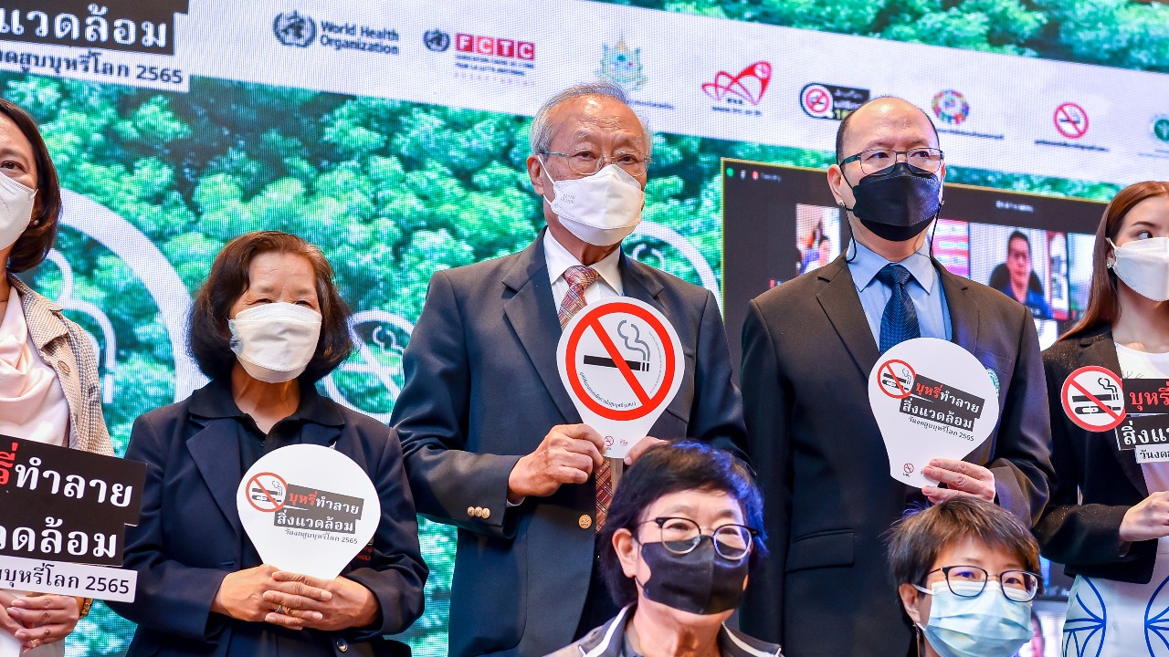 Professor Prakit Vathesatogkit standing by a sign for World No Tobacco Day 2022.