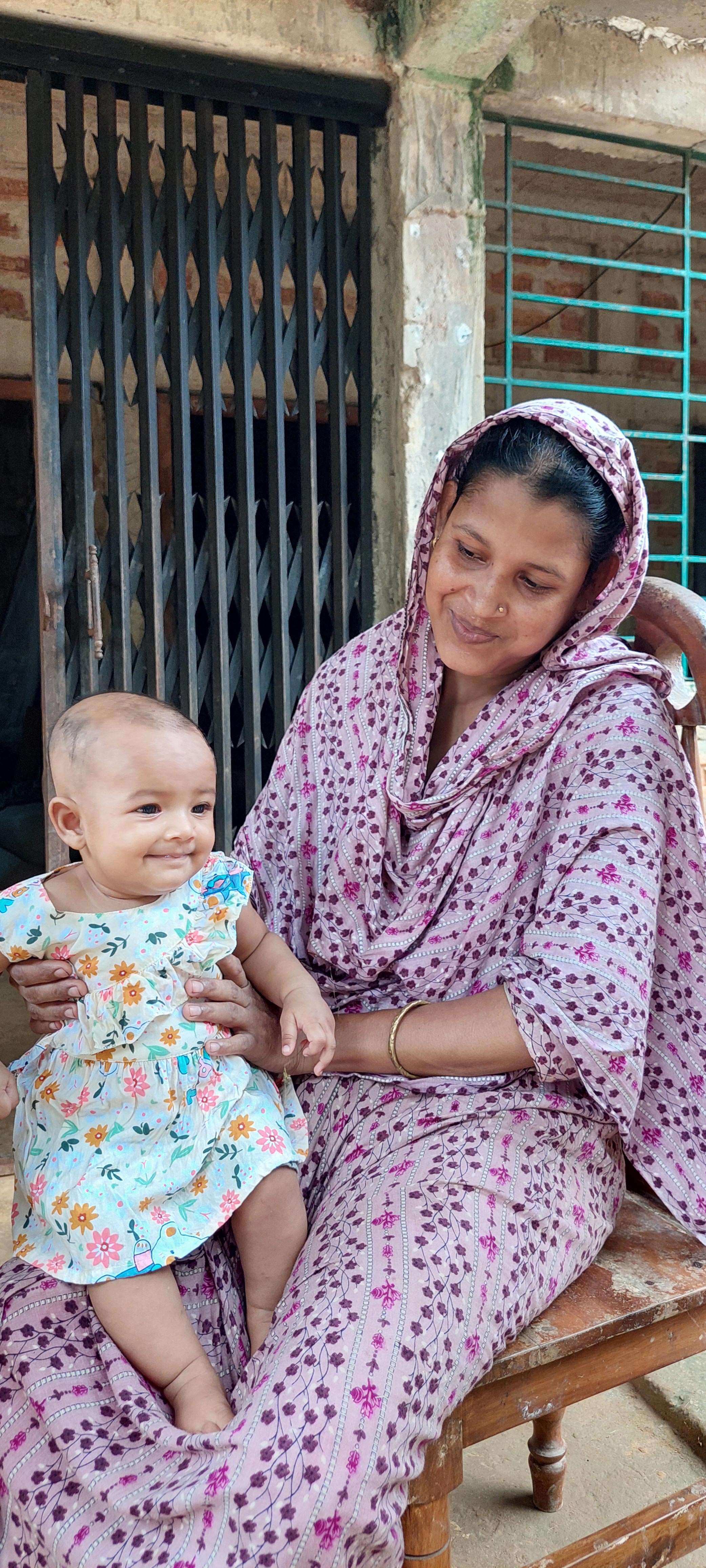 Faliha and her mother Jayna at the vaccination center, preparing for immunization.