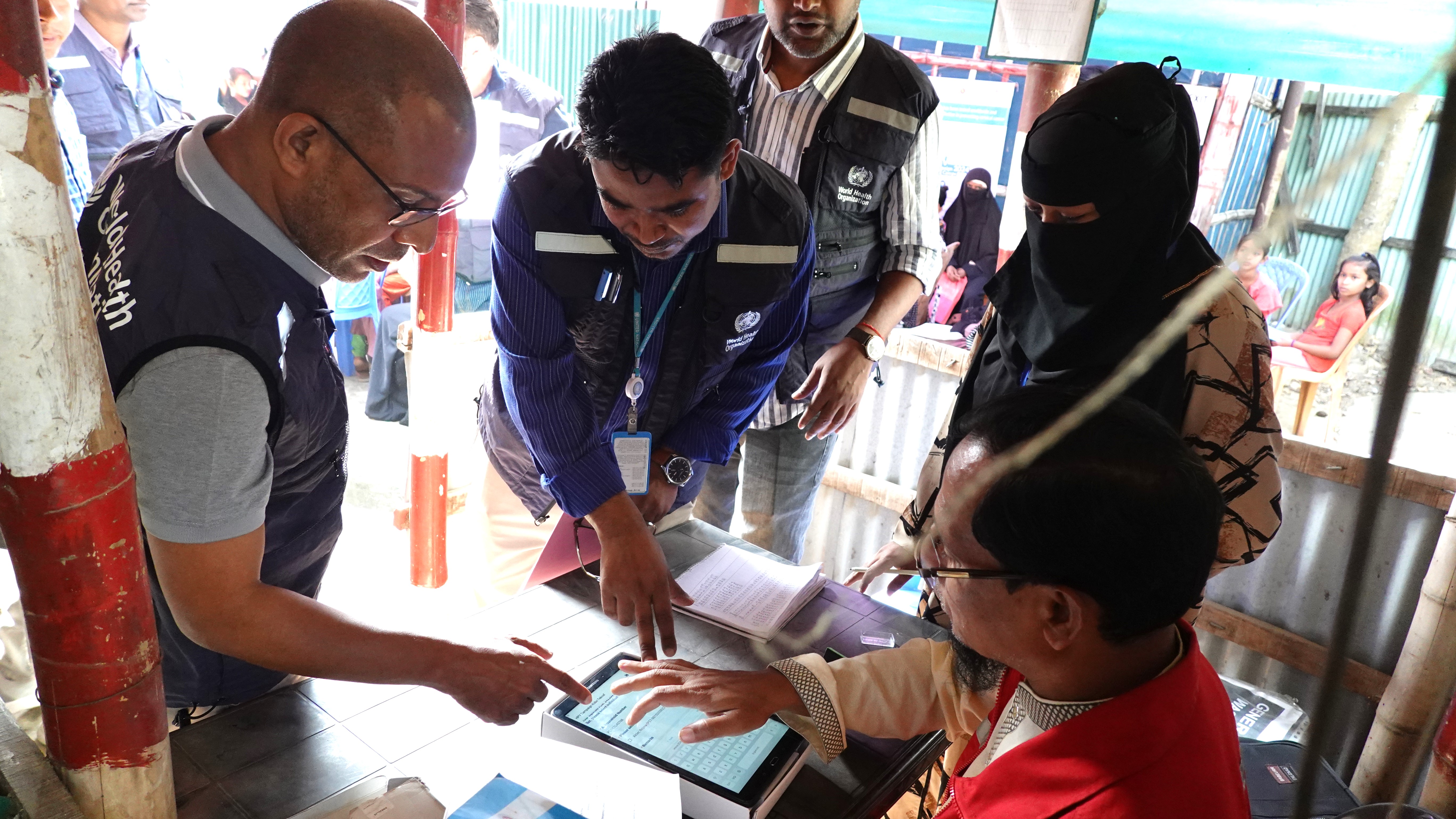 The WR along with a team member examining the Hepatitis C medication at SCI health facility in the Rohingya camps