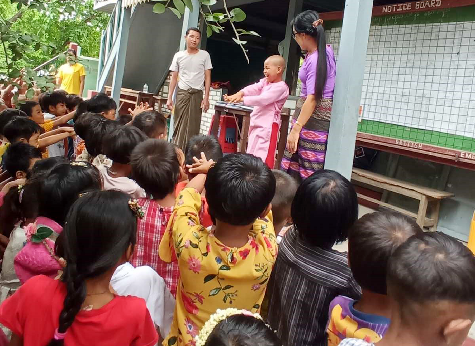 A nun demonstrates hand washing to students of the monastic education school.