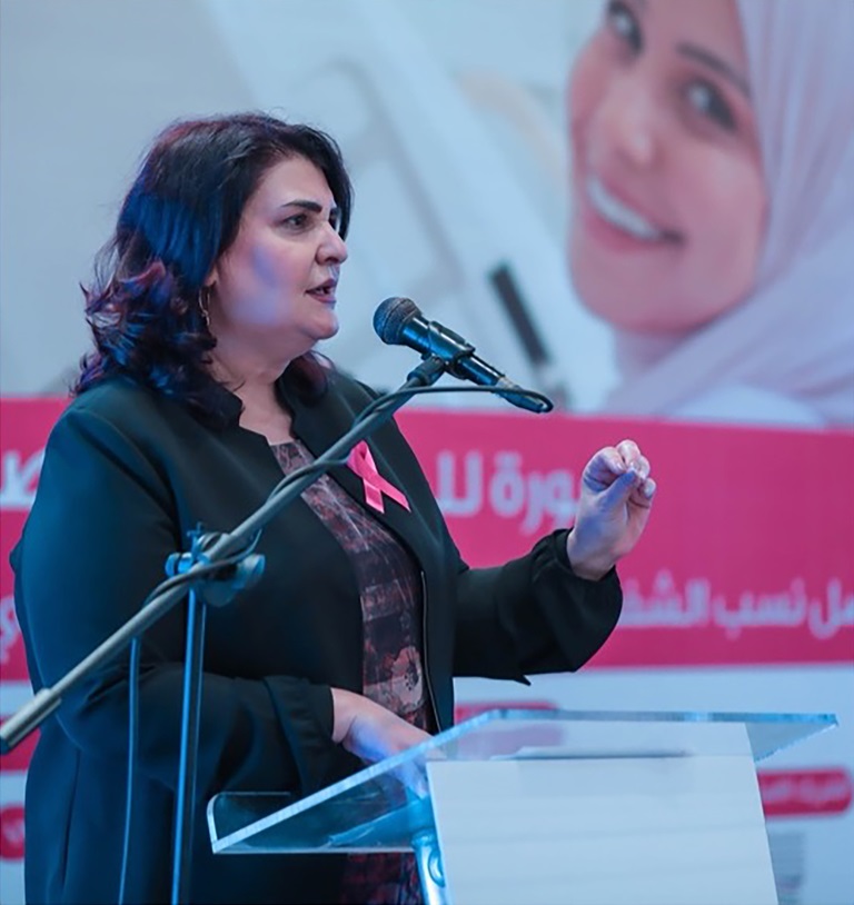 A woman speaking into a microphone at the Aid and Hope Gala Dinner.