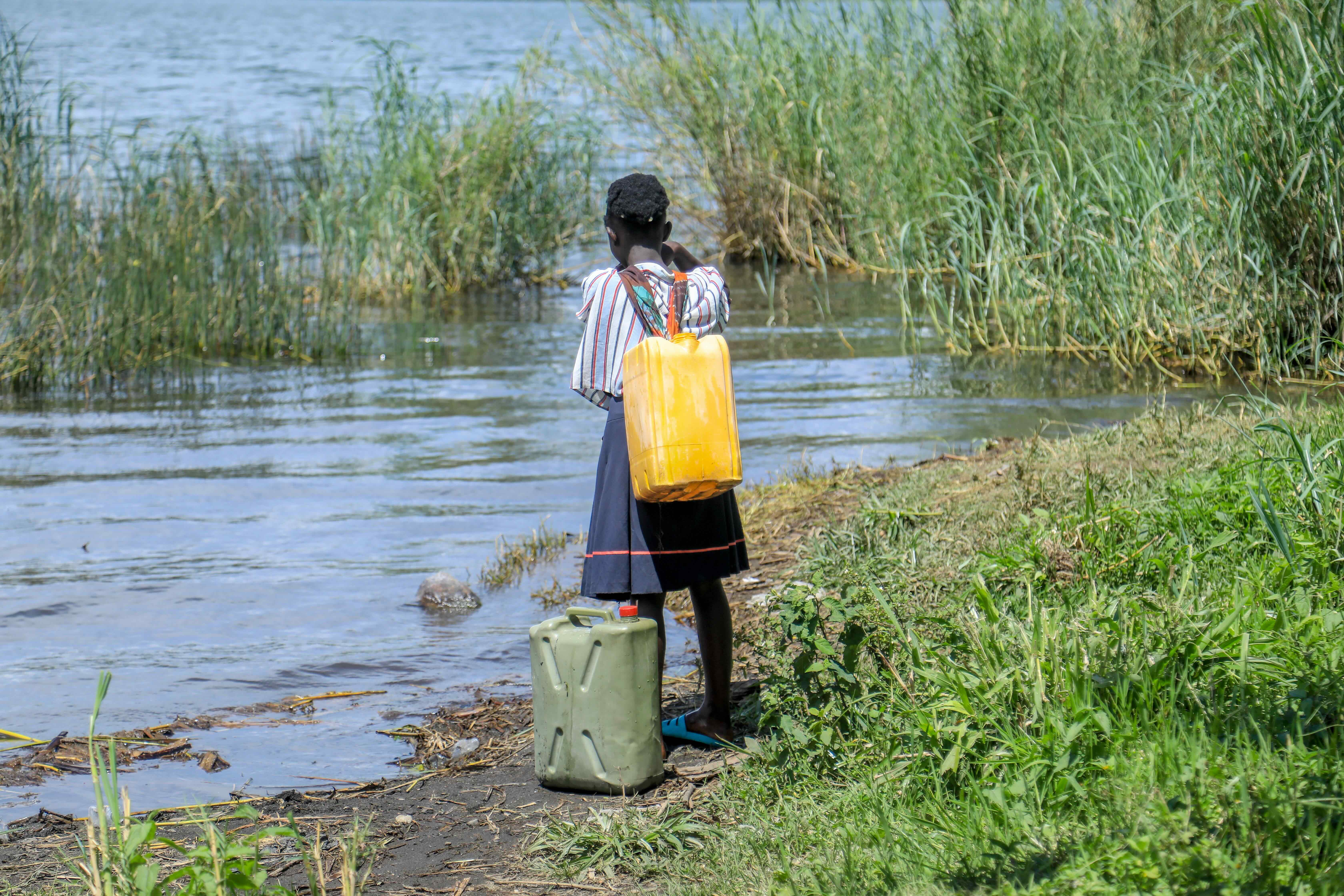 A young girl collects water