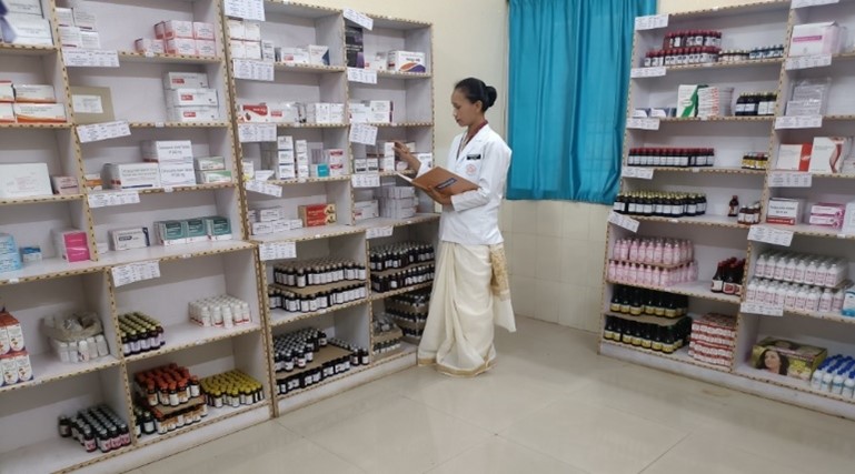 A pharmacist is reviewing stock of medicines.