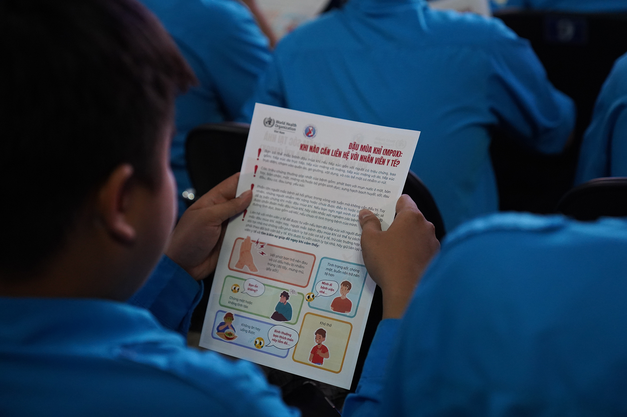Person reading a flyer on mpox