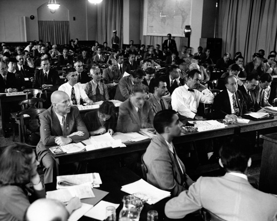 General view of a Plenary Session of the International Health Conference (June-July 1946) with participating delegates sitting at rows of tables