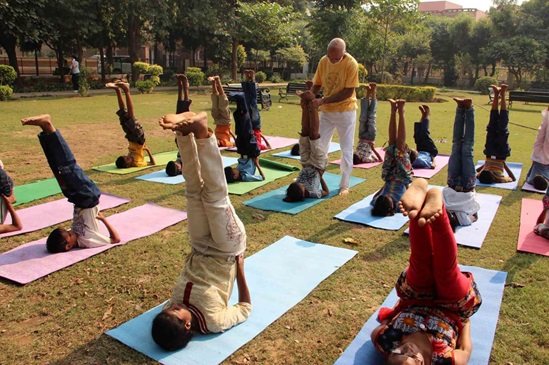 India: children doing yoga in a park
