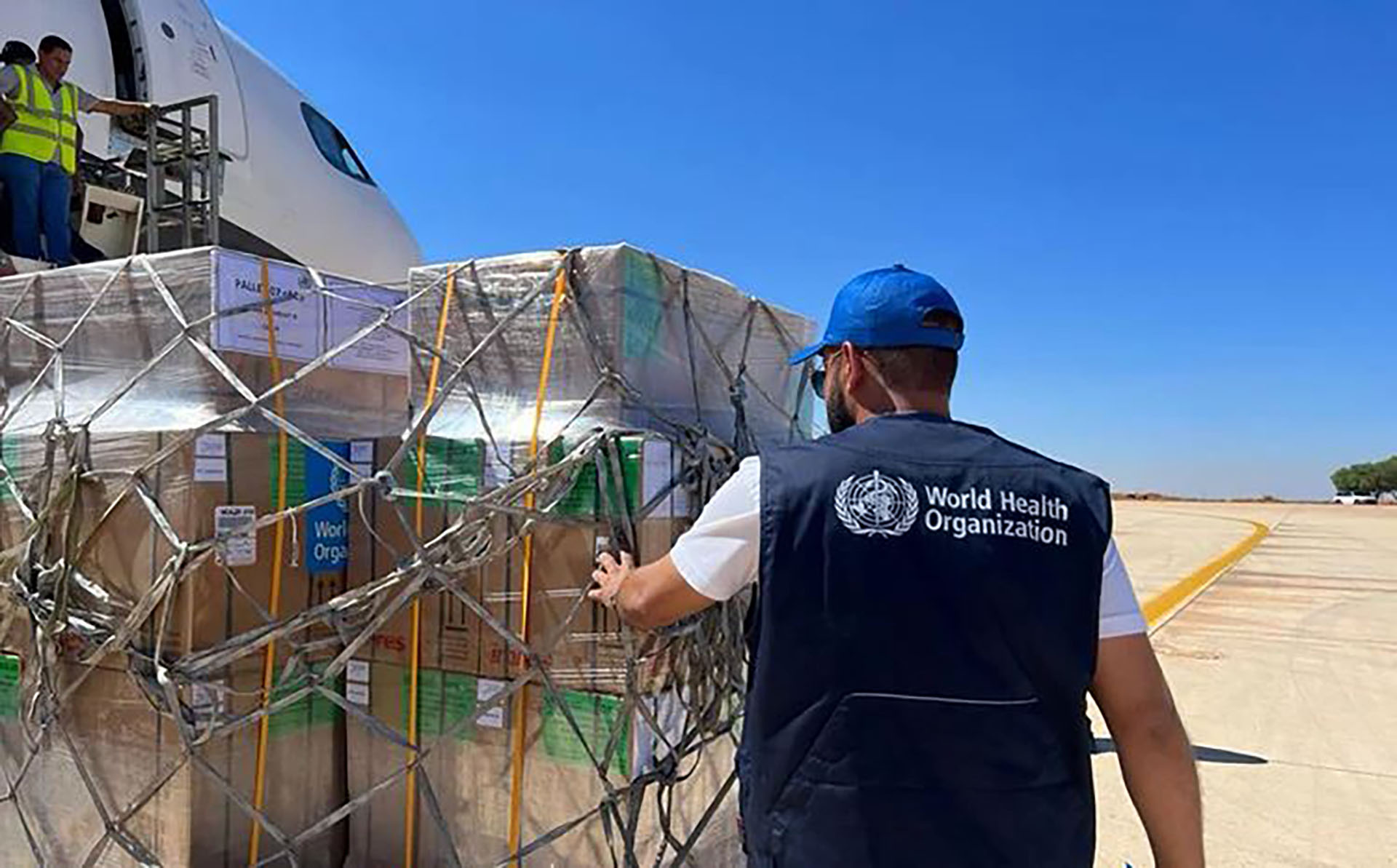 A WHO officer checks on a cargo delivery