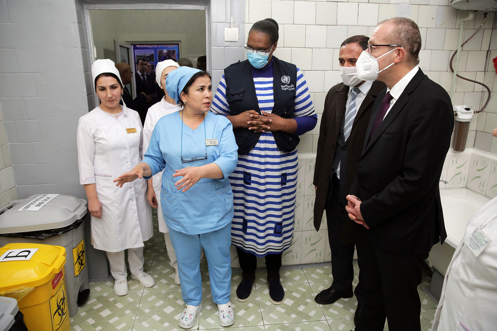 Health workers explain about proper medical waste management to Dr. Hans Kluge