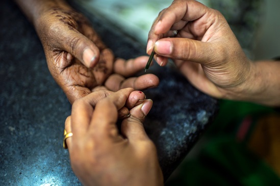 Someone having their fasting sugar level checked, as related to diabetes - a close-up of people's hands.