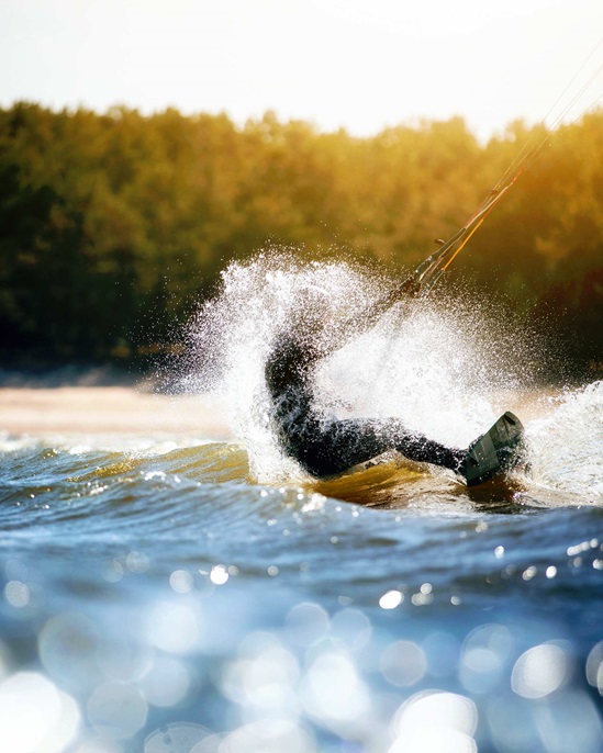 Action shot of somebody kite surfing.
