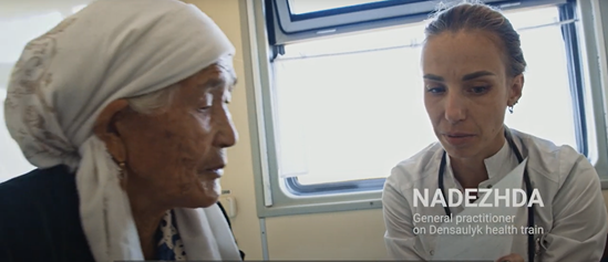 An elderly lady talking to a doctor on a train
